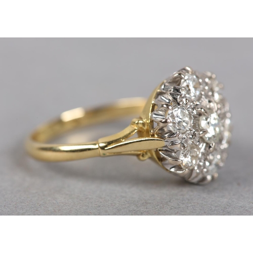 436 - A DIAMOND CLUSTER RING in 18ct yellow and white gold, the brilliant cut stones claw and grain set wi... 