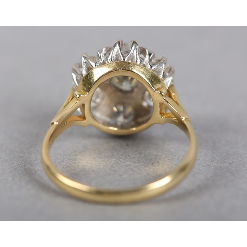 436 - A DIAMOND CLUSTER RING in 18ct yellow and white gold, the brilliant cut stones claw and grain set wi... 