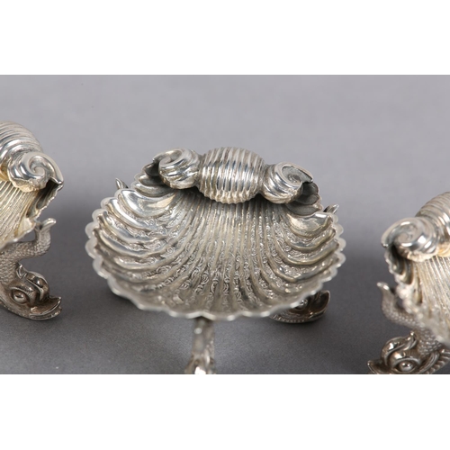 371 - A SET OF THREE VICTORIAN SILVER SHELL SALT CELLARS, Birmingham 1866 for George Unite, each on three ... 