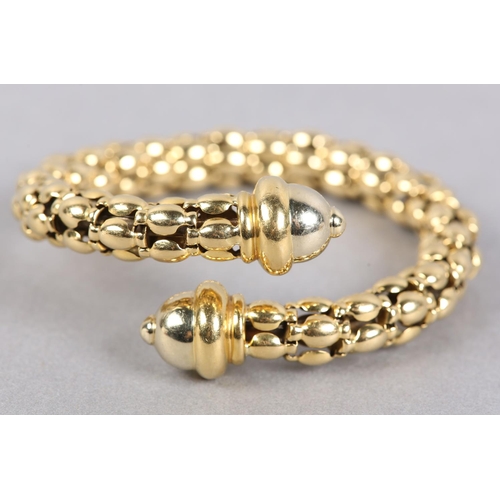 443 - A BANGLE in 18ct gold, the beads of rice type links sprung with boss terminals, approximate weight 5... 