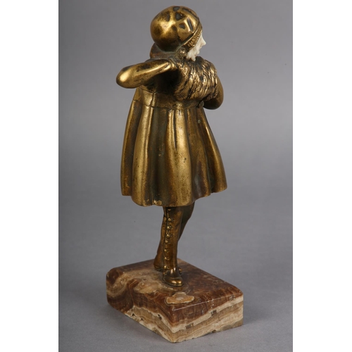 64 - AN ART DECO GILDED BRONZE AND IVORY, of a young girl dressed for the cold with cloche hat and muff, ... 