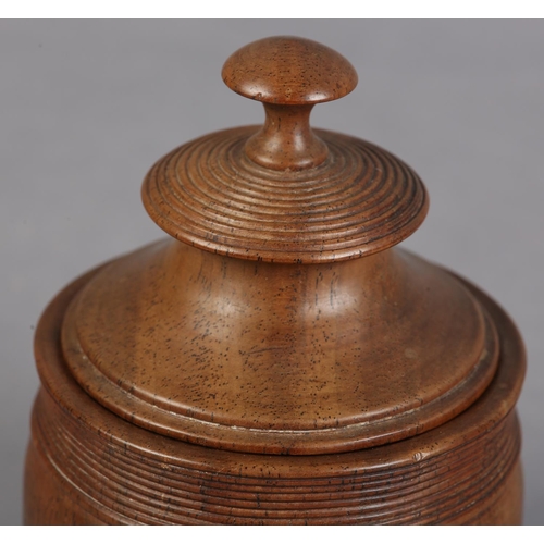 74 - AN EARLY 19TH CENTURY WALNUT TOBACCO JAR AND COVER with knop finial and reeded banding, 14cm high