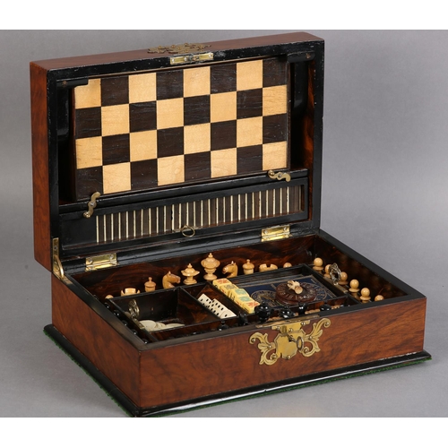 68 - A VICTORIAN WALNUT GAMES COMPENDIUM, with cut brass strapwork and escutcheon, the interior fitted wi... 