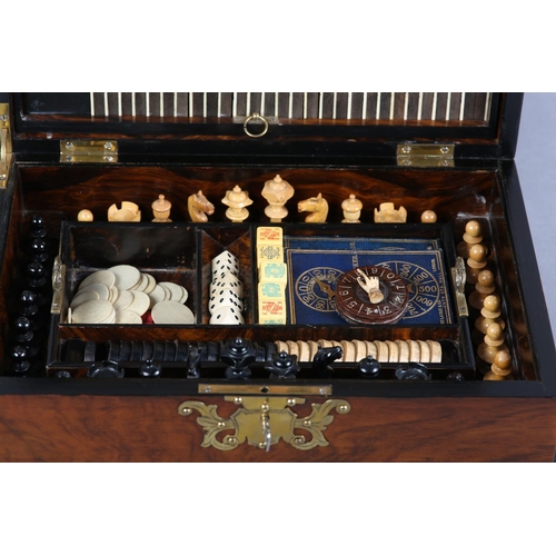 68 - A VICTORIAN WALNUT GAMES COMPENDIUM, with cut brass strapwork and escutcheon, the interior fitted wi... 