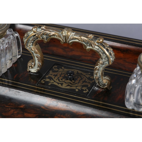 69 - A VICTORIAN COROMANDEL AND BRASS MOUNTED DESK STANDISH, rectangular, having a central brass leaf cas... 