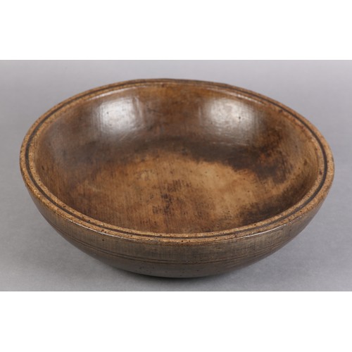 75 - A 19TH CENTURY TURNED FRUIT WOOD DAIRY BOWL, with moulded rim and simple incised line decoration, 35... 