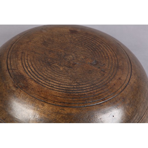 75 - A 19TH CENTURY TURNED FRUIT WOOD DAIRY BOWL, with moulded rim and simple incised line decoration, 35... 