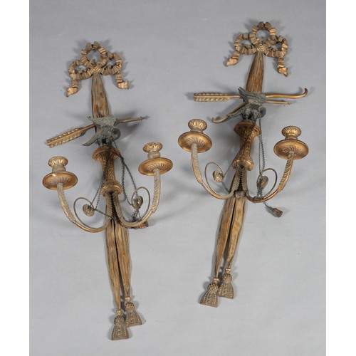 498 - A PAIR OF REGENCY GILTWOOD CANDLE SCONCES, the ribbon-tied drapes with tassels, crossed bow and arro... 