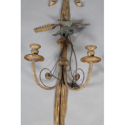 498 - A PAIR OF REGENCY GILTWOOD CANDLE SCONCES, the ribbon-tied drapes with tassels, crossed bow and arro... 