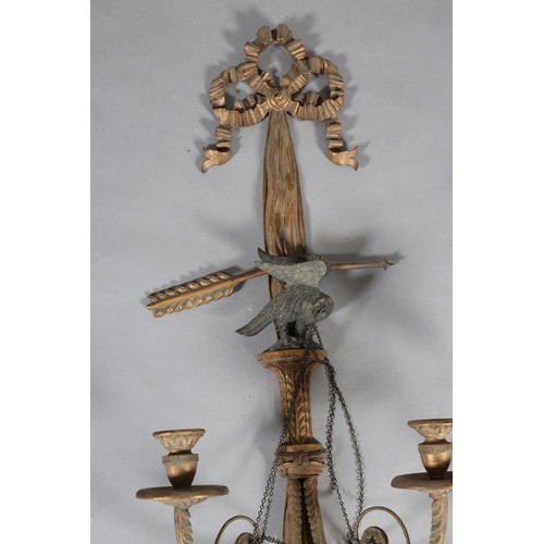 498 - A PAIR OF REGENCY GILTWOOD CANDLE SCONCES, the ribbon-tied drapes with tassels, crossed bow and arro... 