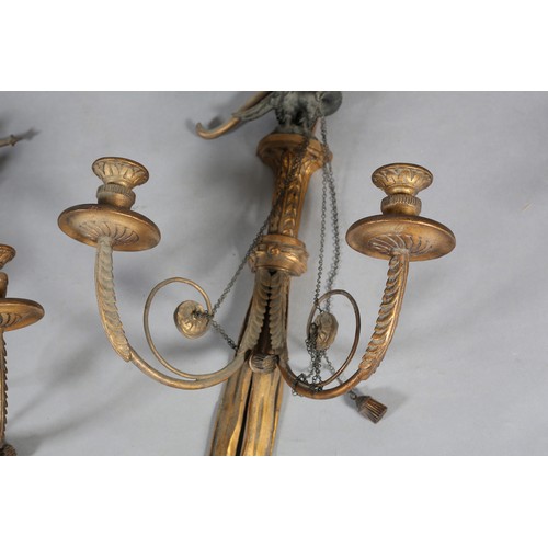 498 - A PAIR OF REGENCY GILTWOOD CANDLE SCONCES, the ribbon-tied drapes with tassels, crossed bow and arro... 