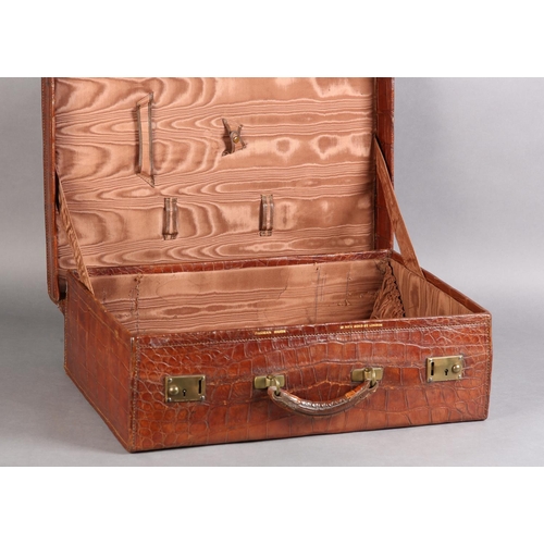 27 - FINNEGAN OF BOND STREET, LONDON, An early 20th century crocodile skin suitcase with moire silk linin... 