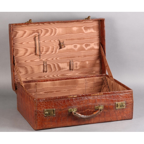 27 - FINNEGAN OF BOND STREET, LONDON, An early 20th century crocodile skin suitcase with moire silk linin... 