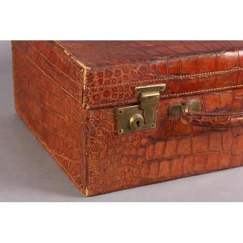 29 - MAPPIN & WEBB LTD, Oxford St London, An early 20th century crocodile skin suitcase, green silk linin... 