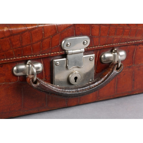 30 - AN EARLY TO MID 20TH CENTURY CROCODILE SKIN SUITCASE, mid blue silk lining with pouch to lid, polish... 