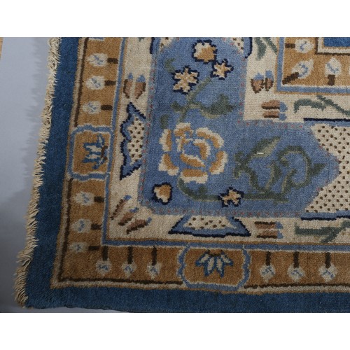 491 - AN ART DECO CHINOISSERIE CARPET, the blue field worked with plant forms, pagodas, butterflies, the p... 