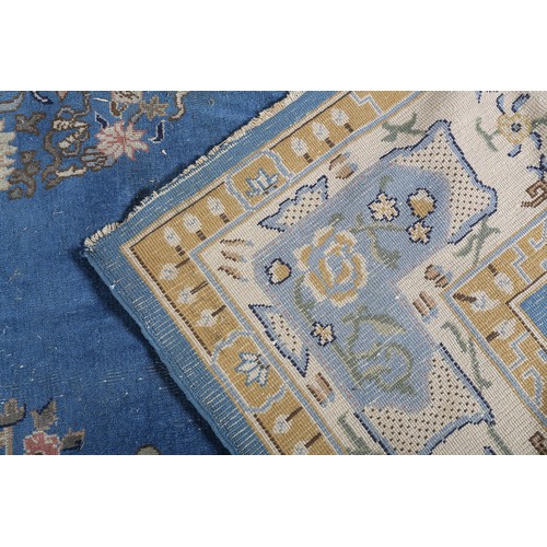 491 - AN ART DECO CHINOISSERIE CARPET, the blue field worked with plant forms, pagodas, butterflies, the p... 