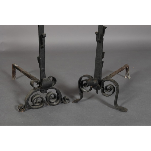 14B - TWO 19TH CENTURY CAST IRON CRESSET FIRE DOGS of similar design, each with basket finials, the tapere... 