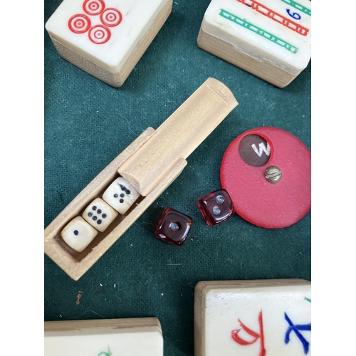 58 - A bamboo and bone mahjong set in a small case with three baize lined trays purchased in Rangoon in 1... 