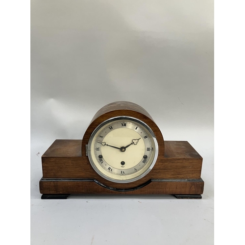 62 - A vintage walnut cased Elliott clock, having a cream enamelled dial with silvered chaptering, roman ... 