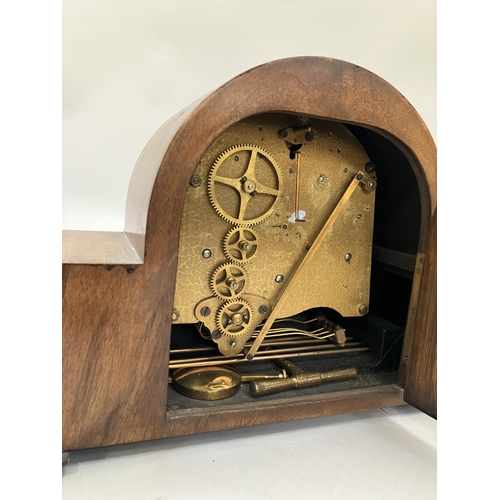 62 - A vintage walnut cased Elliott clock, having a cream enamelled dial with silvered chaptering, roman ... 