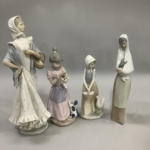 1000 - Three Nao figures and a Nadal figure of girls variously with chicken, rabbit, cat