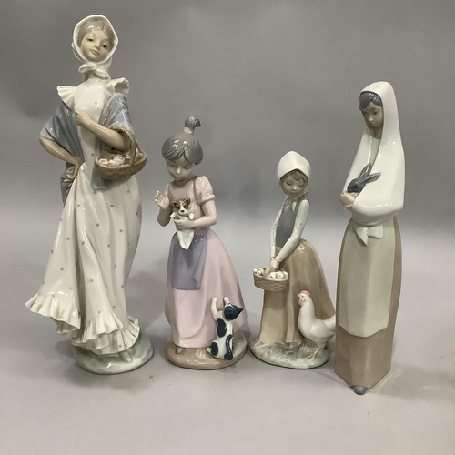 1000 - Three Nao figures and a Nadal figure of girls variously with chicken, rabbit, cat