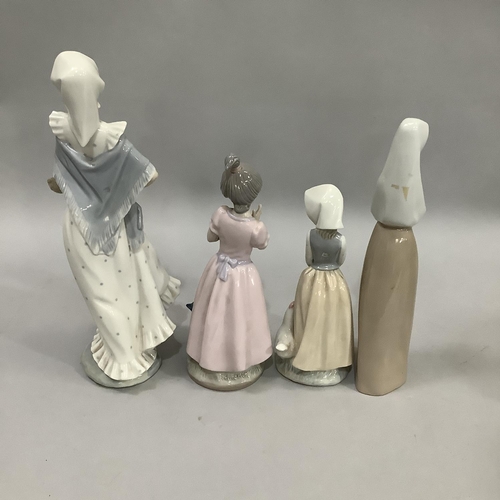 1000 - Three Nao figures and a Nadal figure of girls variously with chicken, rabbit, cat