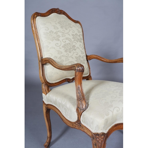 315 - AN 18TH CENTURY FRENCH ELM ELBOW CHAIR, having an encircling moulded frame, carved with leafage, arc... 