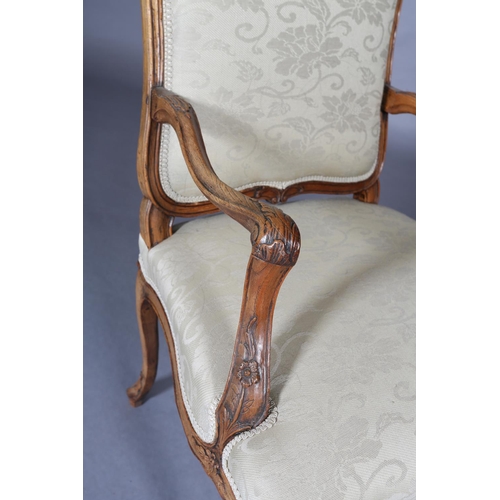 315 - AN 18TH CENTURY FRENCH ELM ELBOW CHAIR, having an encircling moulded frame, carved with leafage, arc... 