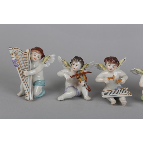 62 - A SET OF NINE VOLKSTEDT PORCELAIN CHERUB MUSICIANS, each playing an instrument (one at fault)