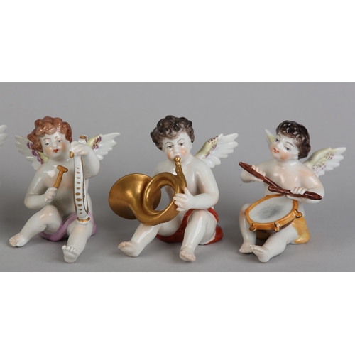 62 - A SET OF NINE VOLKSTEDT PORCELAIN CHERUB MUSICIANS, each playing an instrument (one at fault)