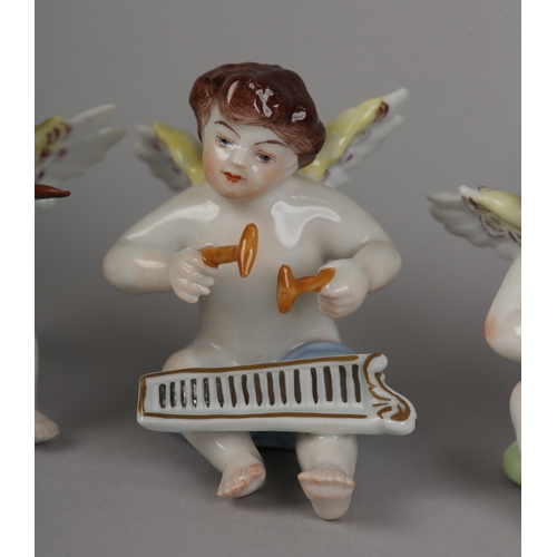 62 - A SET OF NINE VOLKSTEDT PORCELAIN CHERUB MUSICIANS, each playing an instrument (one at fault)