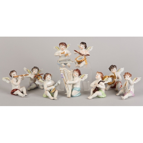 62 - A SET OF NINE VOLKSTEDT PORCELAIN CHERUB MUSICIANS, each playing an instrument (one at fault)