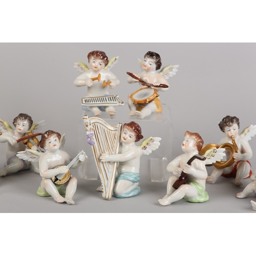 62 - A SET OF NINE VOLKSTEDT PORCELAIN CHERUB MUSICIANS, each playing an instrument (one at fault)