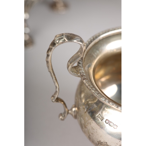 121 - A GEORGE VI FOUR PIECE SILVER TEA SERVICE, Sheffield 1945 for Walker & Hall, compressed circular for... 