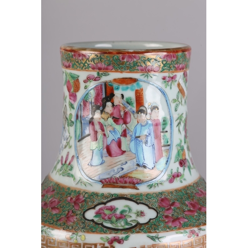 83 - A PAIR OF MID 19TH CENTURY CHINESE FAMILLE ROSE VASES, the shouldered body and ring moulded neck ena... 