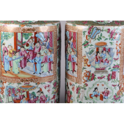 83 - A PAIR OF MID 19TH CENTURY CHINESE FAMILLE ROSE VASES, the shouldered body and ring moulded neck ena... 