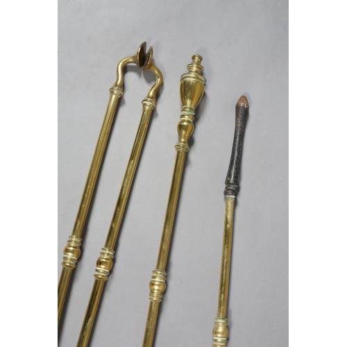 58 - A SET OF THREE VICTORIAN BRASS FIREIRONS with urn shaped terminals comprising poker, shovel and pair... 