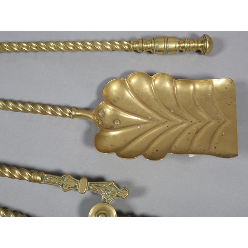 59 - A SET OF THREE VICTORIAN BRASS FIREIRONS with  knopped terminals and writhen handles comprising poke... 