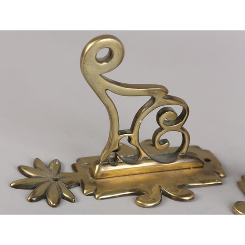 47 - A PAIR OF EARLY 19TH CENTURY BRASS WALL BRACKETS, the back plate with foliate finial, scrolled and p... 