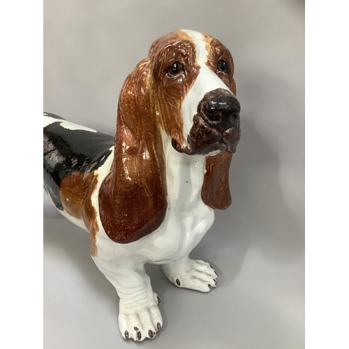 1 - A ceramic life size model of a Basset hound, glazed and painted in black and tan on white ground, ap... 