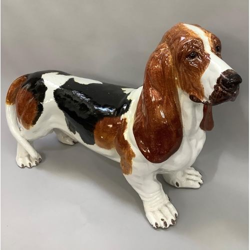 1 - A ceramic life size model of a Basset hound, glazed and painted in black and tan on white ground, ap... 