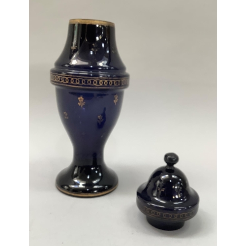 24 - A 19th century blue glass vase and cover printed in gilt with sprigs of flowers, leaf and circlet bo... 