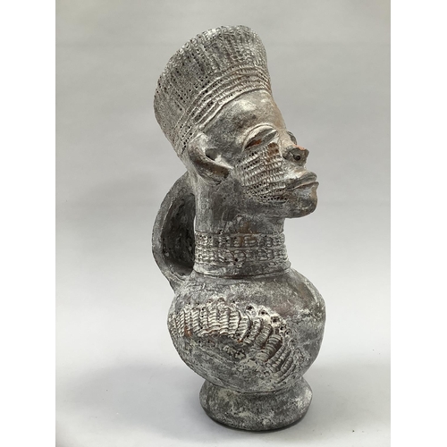 25 - A 20th century terracotta Mangbetu vessel, Republic of Congo, facemask and headdress above a rounded... 