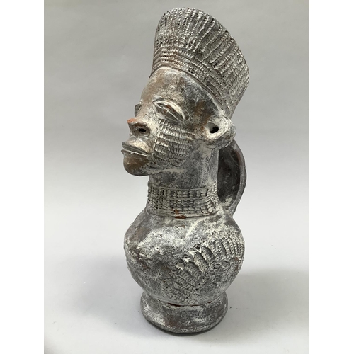 25 - A 20th century terracotta Mangbetu vessel, Republic of Congo, facemask and headdress above a rounded... 