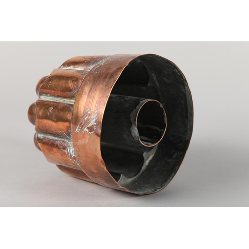 3 - A 19th century copper jelly mould with central pipe, engraved with coronet over SH, 13.5cm diameter ... 