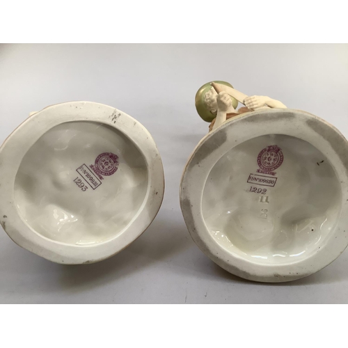 5 - A pair of Royal Worcester blush ivory and pale green gilded figures of a girl holding a nest of bird... 