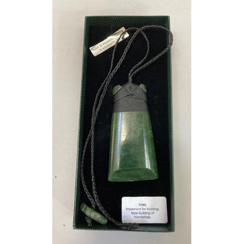 52 - A New Zealand jade pendant toggle fastening of tapered outline with cord, in original case together ... 
