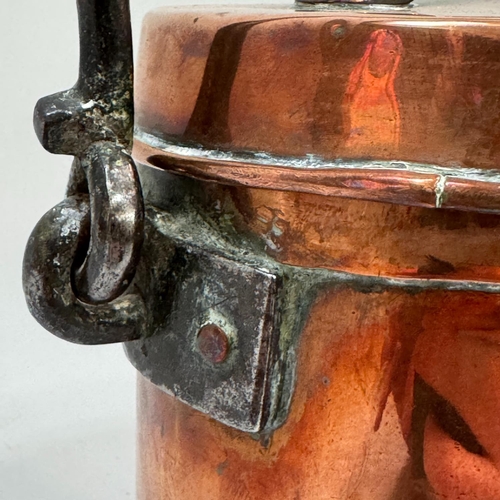 55 - A Victorian/Edward VII copper vessel, the flat lid with strapwork handle and with iron hooped swing ... 